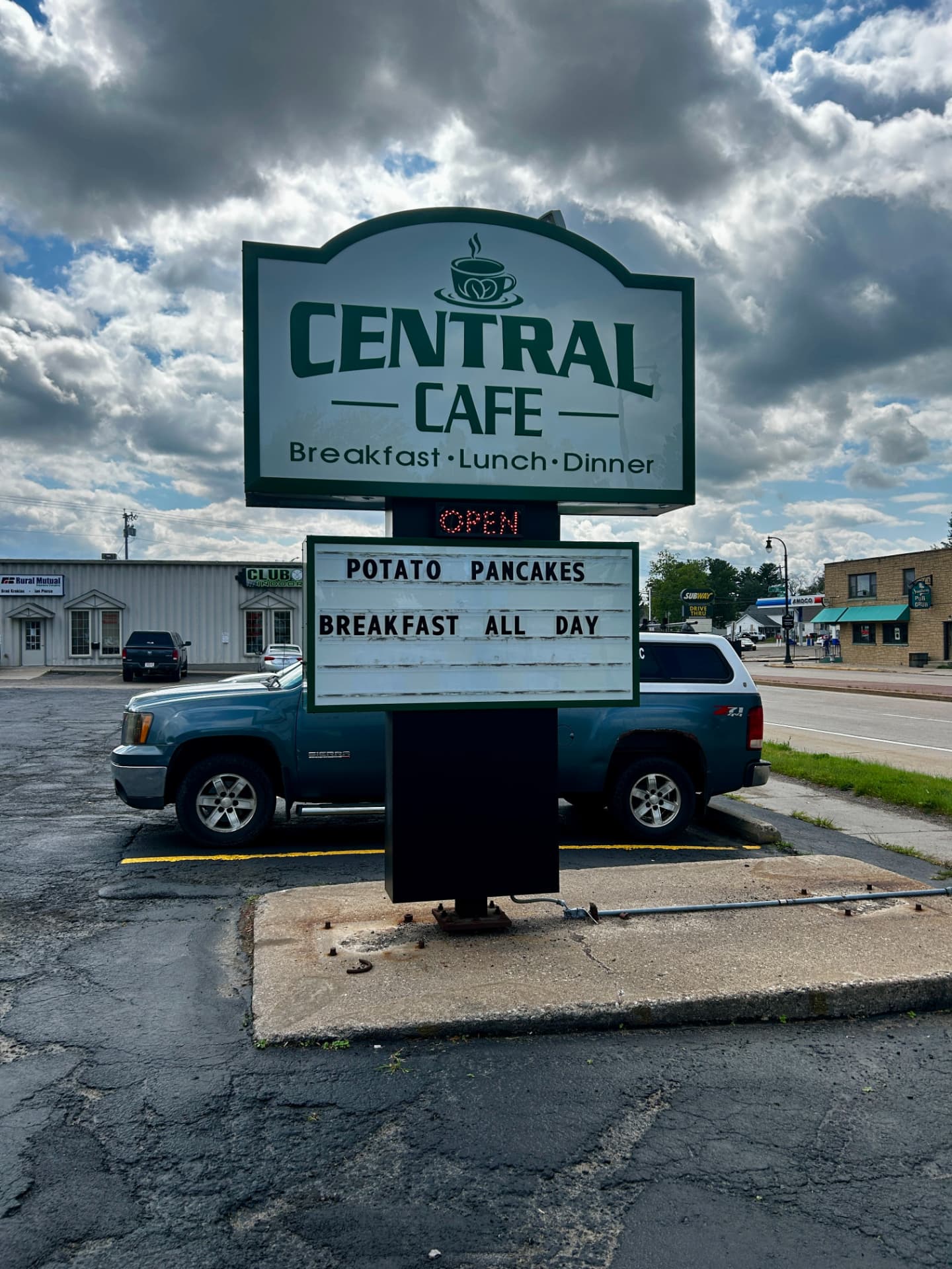 The Central Cafe road sign on South Central Avenue in Marshfield, Wisconsin, with Potato Pancakes and Breakfast All Day on the marquee